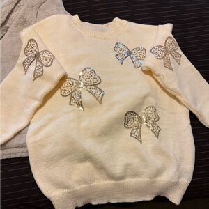 Cream sweater with gold bows
